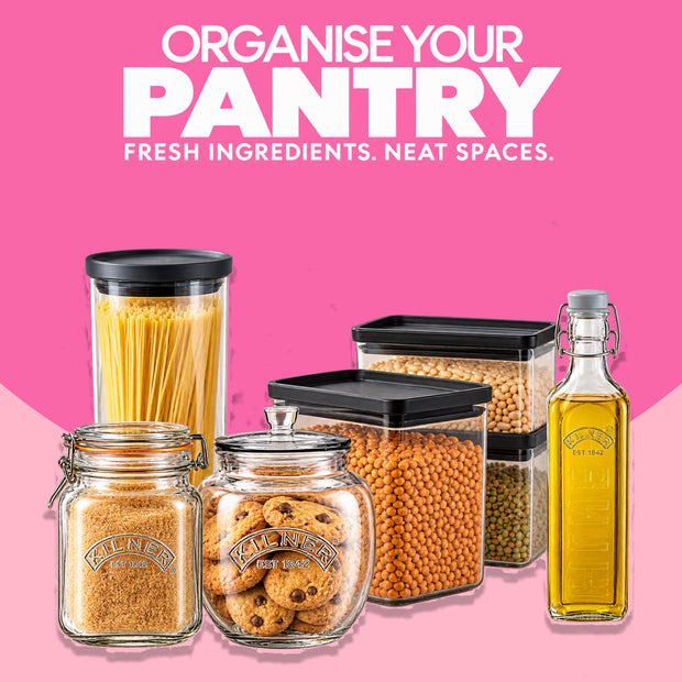 Organise Your Pantry collection featuring Kilner glass storage jars, a Kilner spaghetti container, clear pantry storage containers with black lids filled with dry foods and pulses, and a Kilner glass oil bottle, arranged against a pink background for organised kitchen and pantry storage at Napev Ghana.
