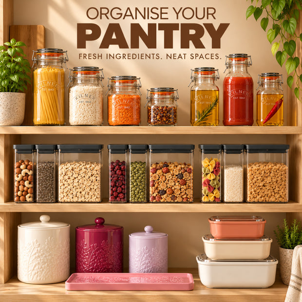 Organise Your Pantry collection featuring Kilner clip top glass storage jars, Joseph Joseph black lid pantry containers, Kilner glass bottles for oils and sauces, reusable food storage containers, and decorative ceramic kitchen canisters arranged across three wooden pantry shelves.