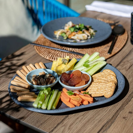 Dalebrook Mineral Agate grey platter serving crackers, vegetable sticks, dried fruit and nuts in small ramekins.