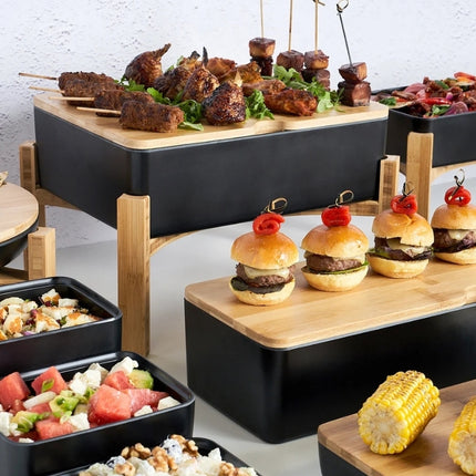 Dalebrook Nimble buffet stands arranged at different heights with skewers, sliders, salads and corn for catering service.