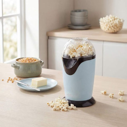 Popcorn maker with popped popcorn on a kitchen counter