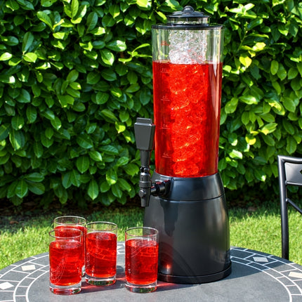 Ice-core beverage dispenser filled with a red chilled drink, displayed outdoors with four filled glasses.