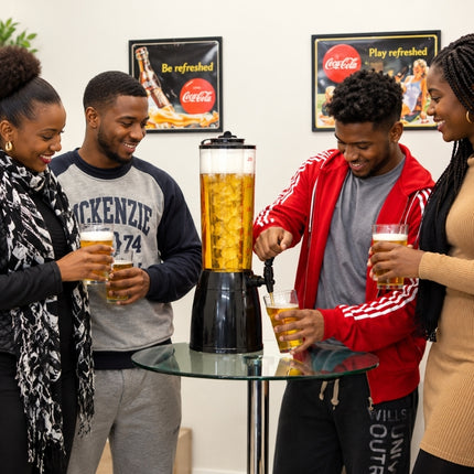 Four friends gathered around an ice-core beverage dispenser as a golden drink is poured into a glass.