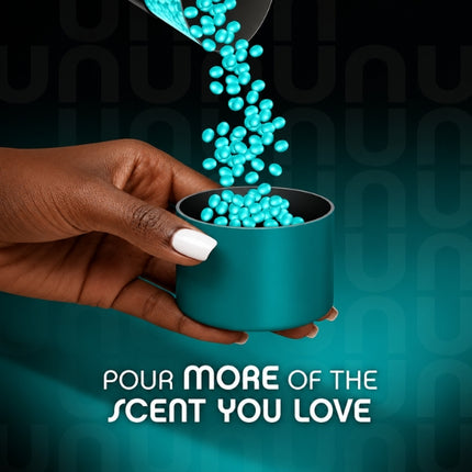 Turquoise Lenor Unstoppables scent booster beads pouring into a measuring cap held by hand, with the message “Pour more of the scent you love.”