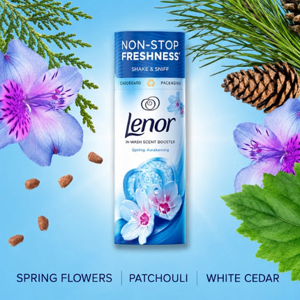 Lenor Spring Awakening scent booster surrounded by flowers, cedar and patchouli, illustrating its spring flowers, patchouli and white cedar fragrance notes.