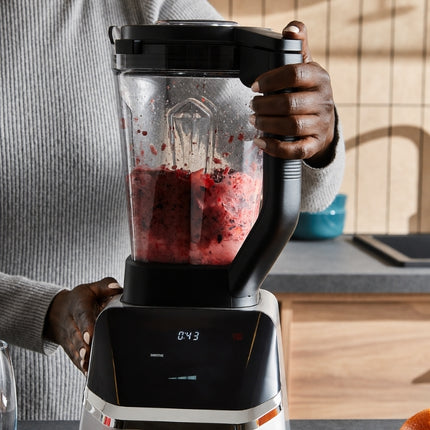 Person operating the Morphy Richards blender as it processes a coarse berry mixture, with the digital countdown showing 43 seconds.