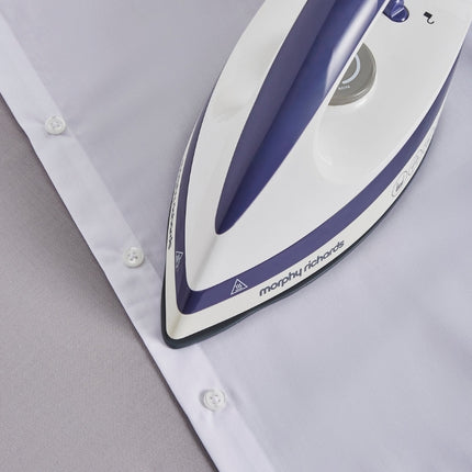 Close-up of the Morphy Richards steam iron’s pointed tip pressing around the buttons of a white shirt.