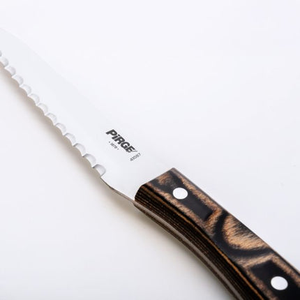 Serrated knife with wooden handle on a white background