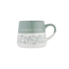 A ceramic mug with a sage green upper half, white lower half, and a delicate floral line-art pattern around the middle. The mug features the handwritten text 'keep growing, keep going' on the green section and has a matching sage green handle.
