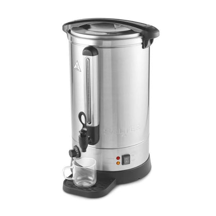 A stainless steel commercial coffee or tea dispenser with black plastic lid, handle, and base components, shown on a plain white background with a clear glass cup placed on the drip tray.