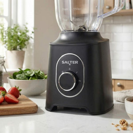 Black Salter blender on a kitchen counter with ingredients in the background