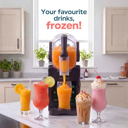 A countertop beverage dispenser machine in a bright kitchen setting, shown dispensing orange frozen drink into a glass, with four finished drinks lined up in front. Text at the top reads 'Your favourite drinks, frozen!'.