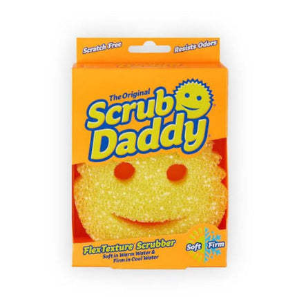 A package of The Original Scrub Daddy FlexTexture Scrubber, featuring a bright orange box with a yellow smiley-face sponge visible through a cutout window.
