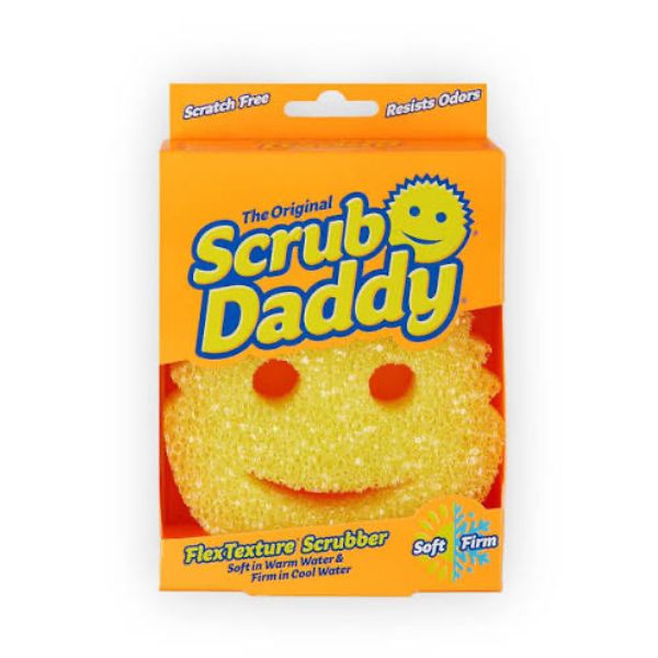 A package of The Original Scrub Daddy FlexTexture Scrubber, featuring a bright orange box with a yellow smiley-face sponge visible through a cutout window.