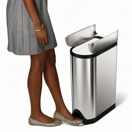 Simplehuman 18L Butterfly Pedal Bin shown open as a user presses the foot pedal, revealing the split-lid opening mechanism.