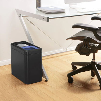 Simplehuman 20L Slim Open Recycler Bin in matte black positioned beside a desk in a contemporary home office.