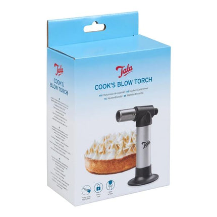 Tala Cook's Blow Torch retail packaging box, featuring a light blue and white design with a photo of the silver and black torch and a meringue-topped pastry.