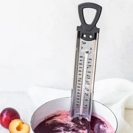 Tala jam thermometer with black loop handle measuring the temperature of purple plum jam in a glass bowl