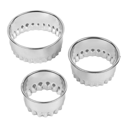 Three metal cookie cutters with textured edges on a white background