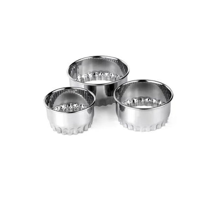 Set of three metal tart tins on a white background