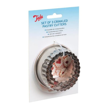 A set of three Tala brand crinkled pastry cutters in a clear plastic blister pack with a blue header card. The cutters have a silver metal base with a pink and white floral pattern.