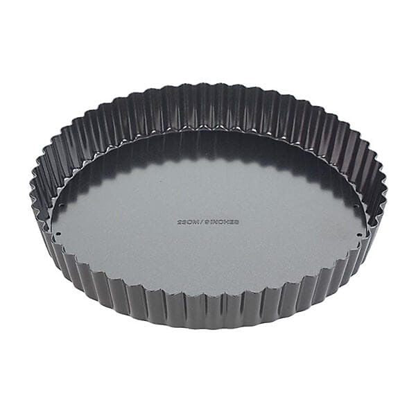 A round fluted tart pan with a dark gray non-stick interior and a black exterior, shown from a top-down angle on a white background.