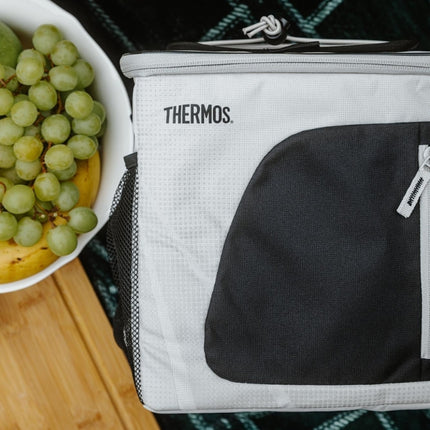 Thermos Radiance 17L family cool bag at a picnic beside a bowl of green grapes and bananas.