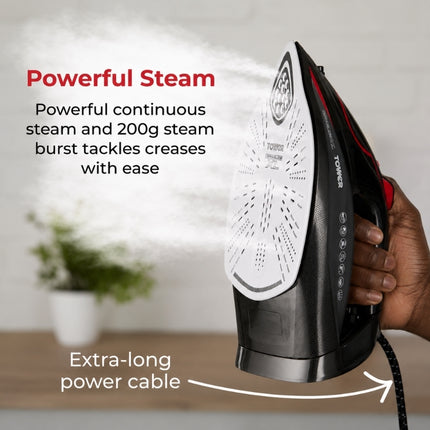Person holding the Tower steam iron upright as it releases steam, highlighting continuous steam, a 200g steam burst and extra-long cable.